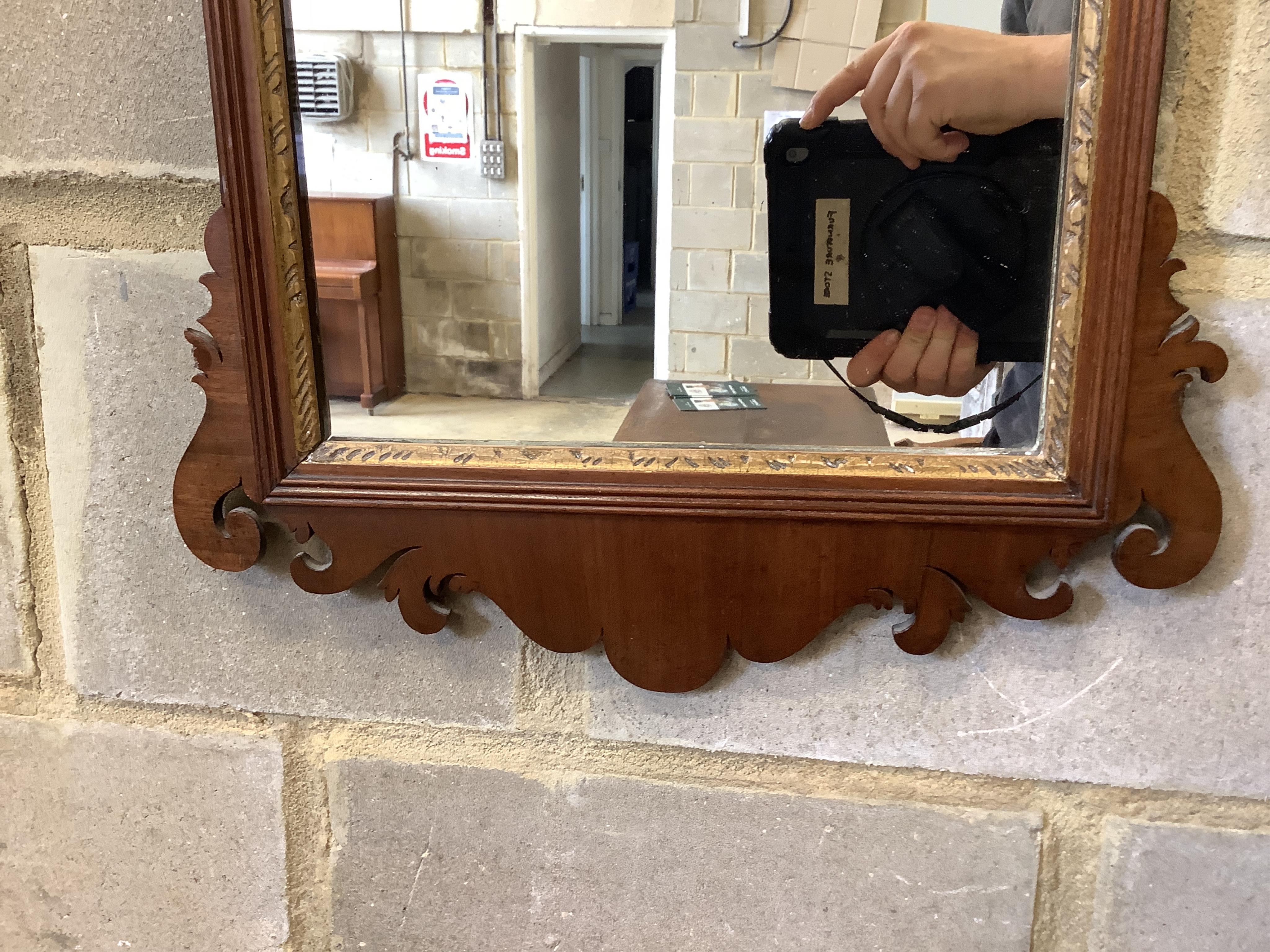 A George III mahogany fret cut wall mirror, width 43cm, height 78cm. Condition - good